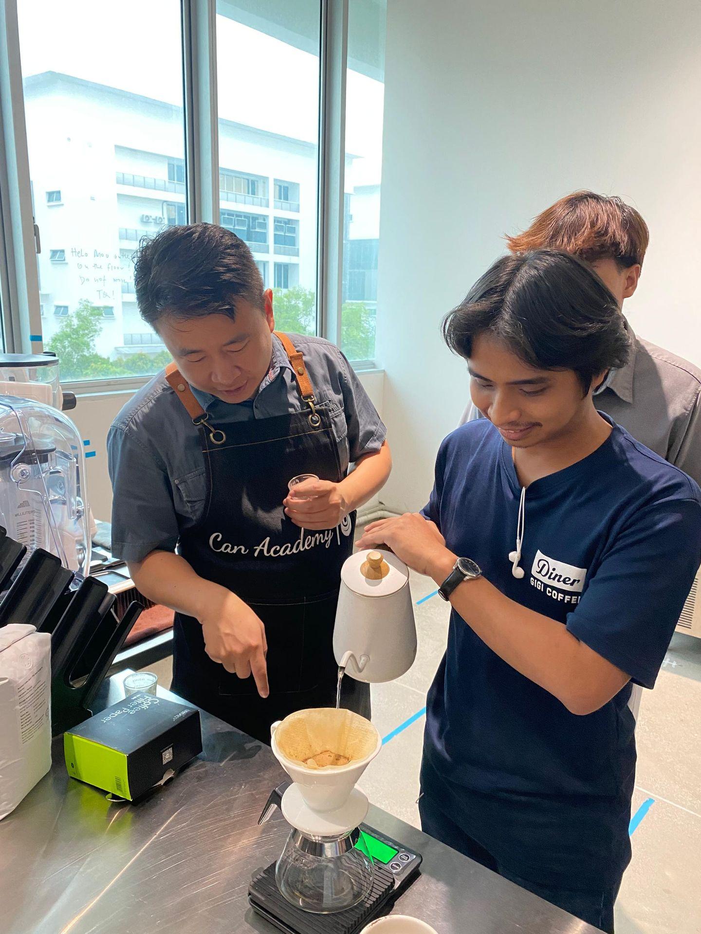 SKM barista training moment as CAN Academy trainer explains pour over steps